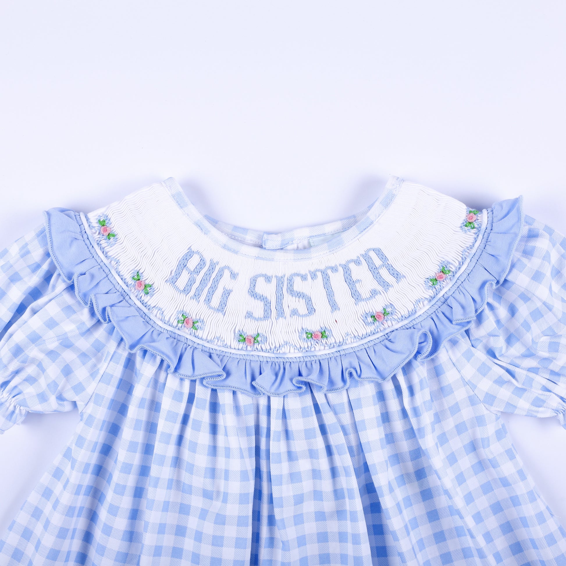 Detailed front smocked collar reading Big Sister with delicate floral hand embroidery on blue gingham.
