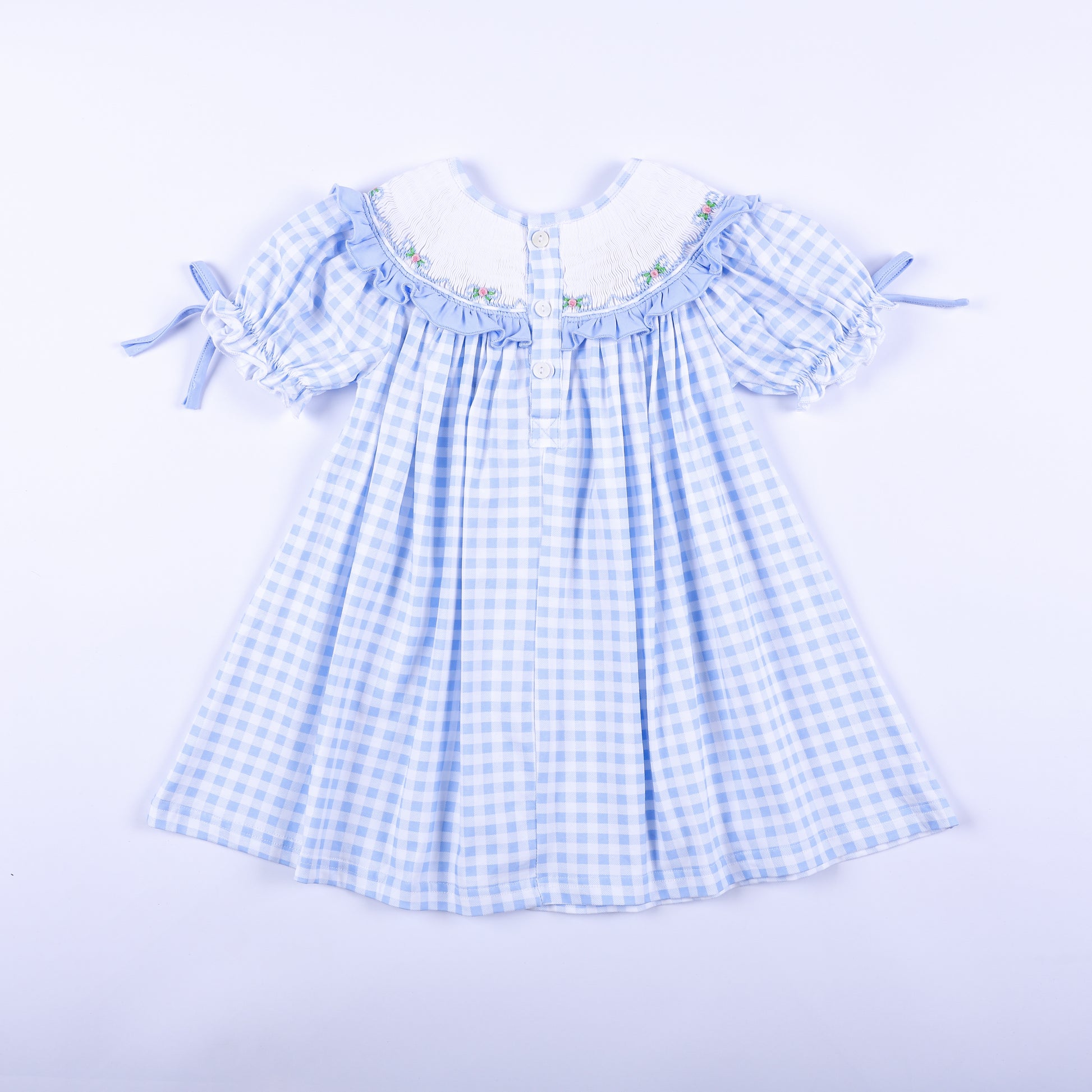 Back view of the light blue gingham Big Sister hand-smocked dress showing classic button closure details.