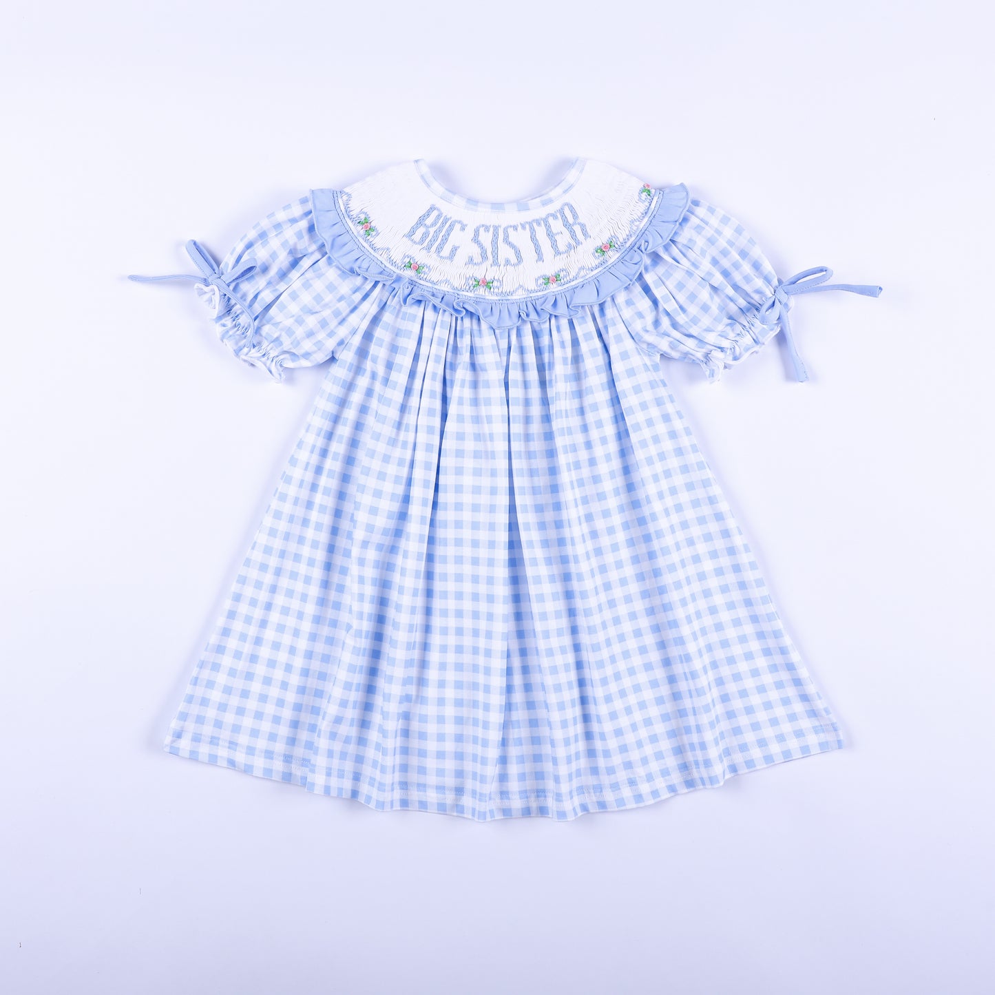 Front view of a light blue gingham big sister hand-smocked dress featuring delicate embroidery.
