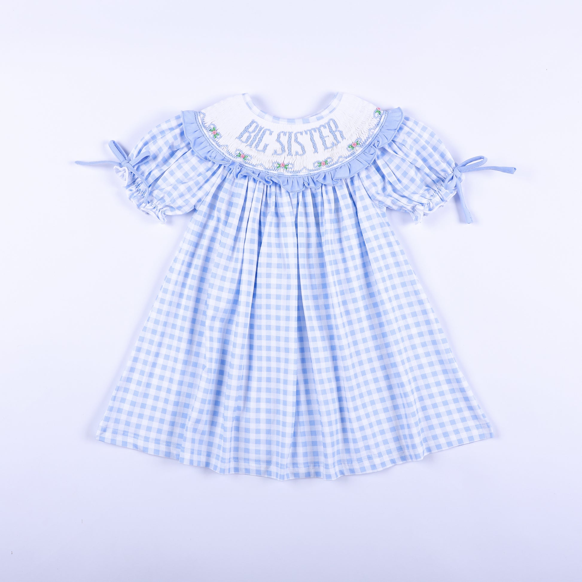 Front view of a light blue gingham big sister hand-smocked dress featuring delicate embroidery.