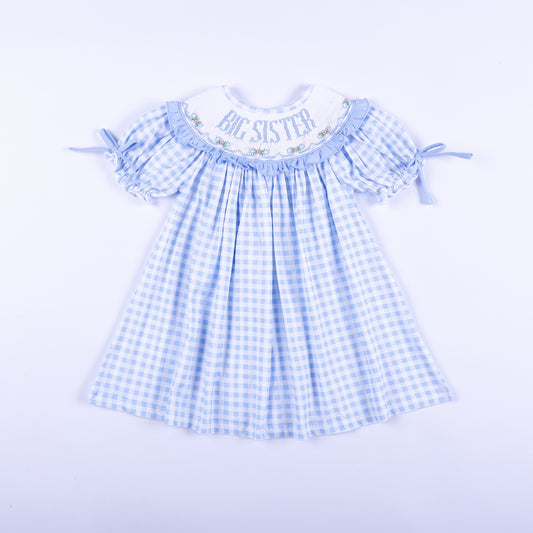 Front view of a light blue gingham big sister hand-smocked dress featuring delicate embroidery.