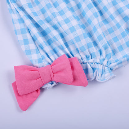 Detail of blue gingham diaper cover bloomer featuring soft elastic leg opening and pink side bow accent.