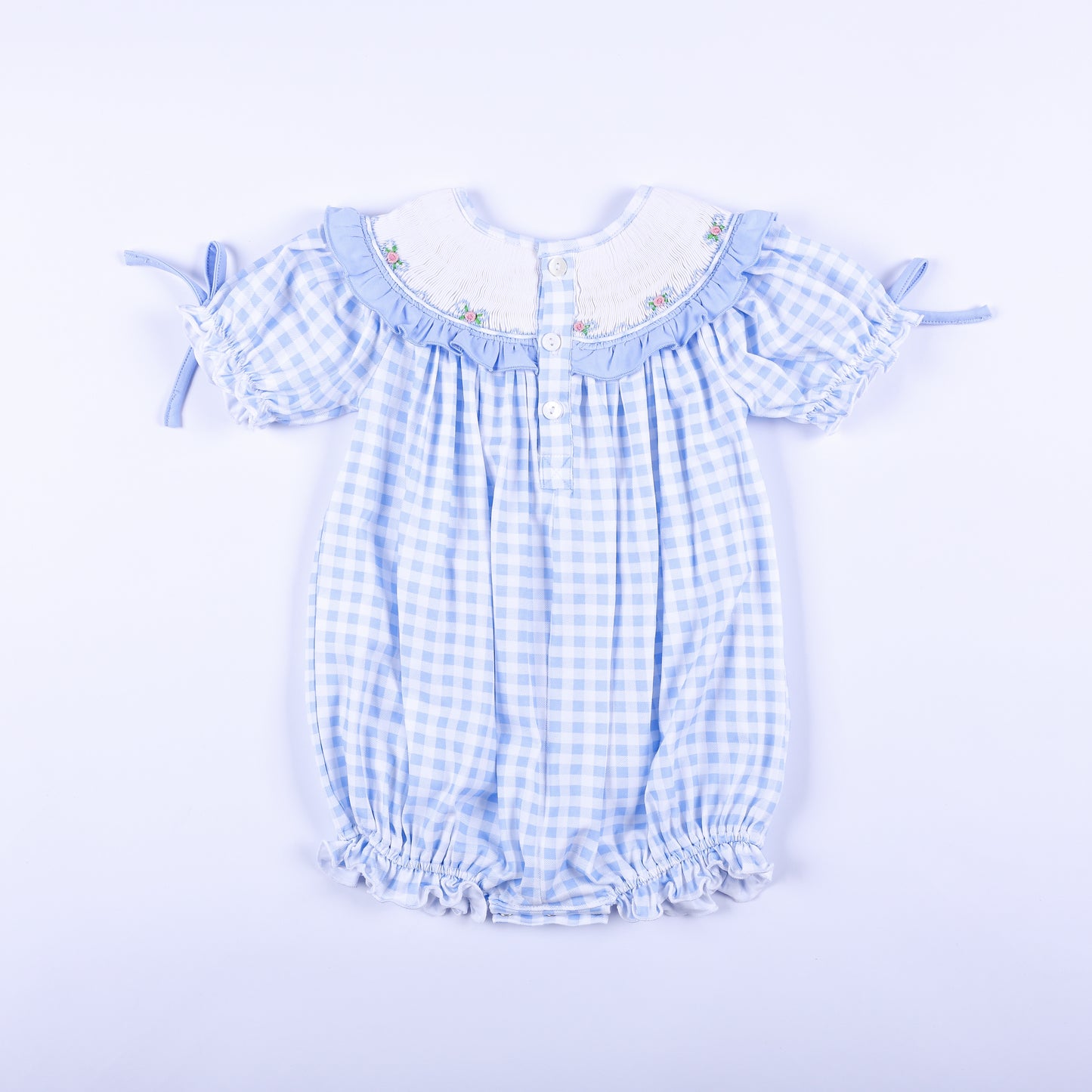 Full back view of light blue gingham hand-smocked Little Sister bubble romper showing back button closure.