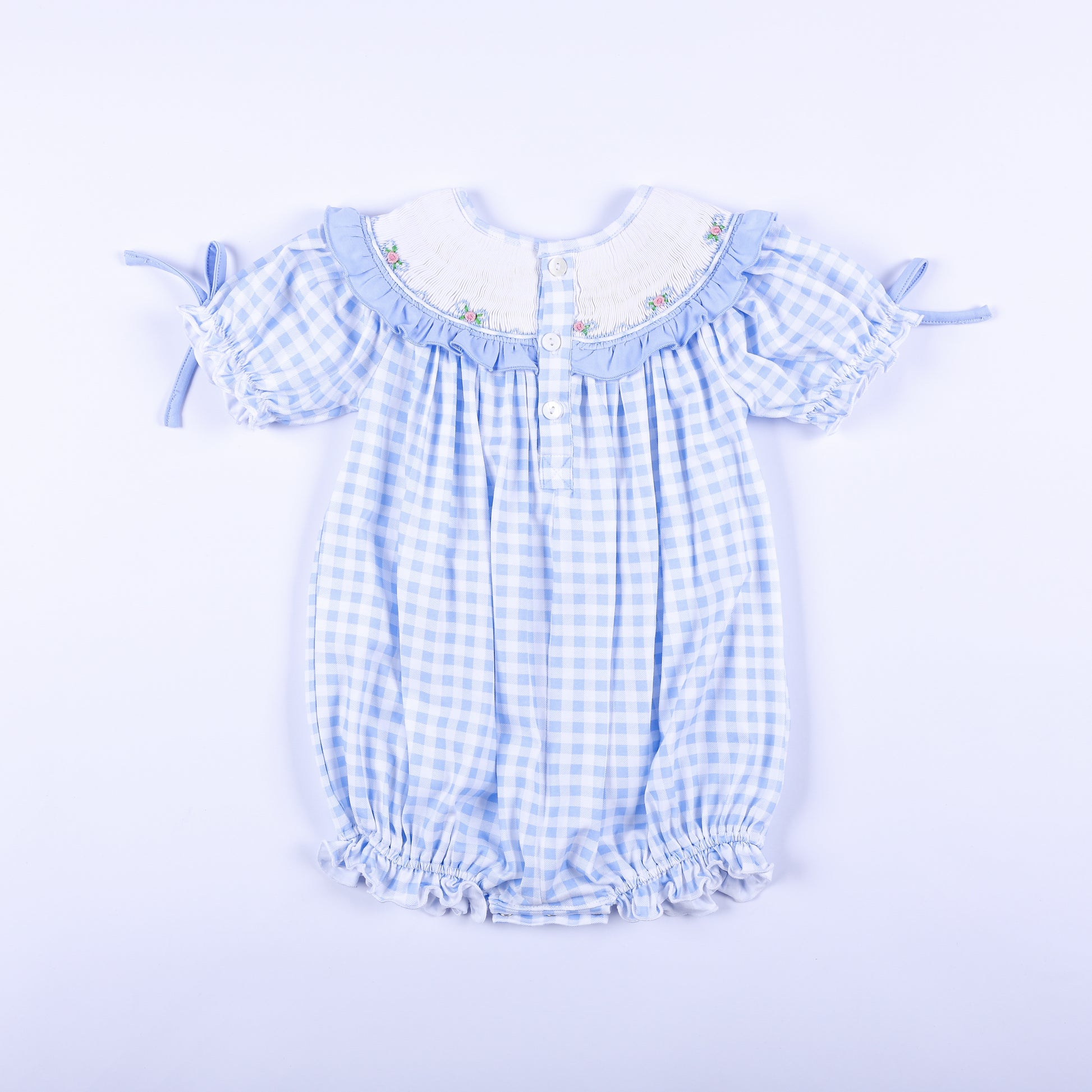 Full back view of light blue gingham hand-smocked Little Sister bubble romper showing back button closure.