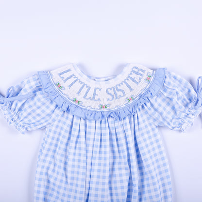 Detailed front collar of blue gingham bubble showing hand-smocked Little Sister text and delicate rose embroidery.
