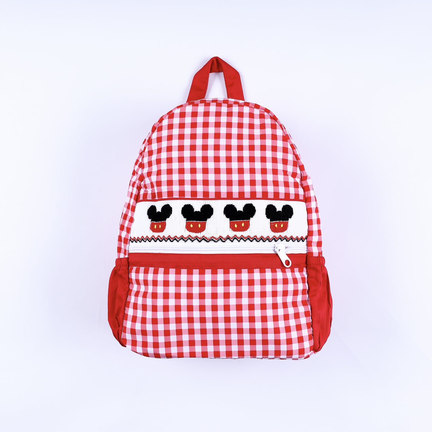 Front view of hand-smocked boys Mickey Mouse red gingham full-size backpack with embroidered details.
