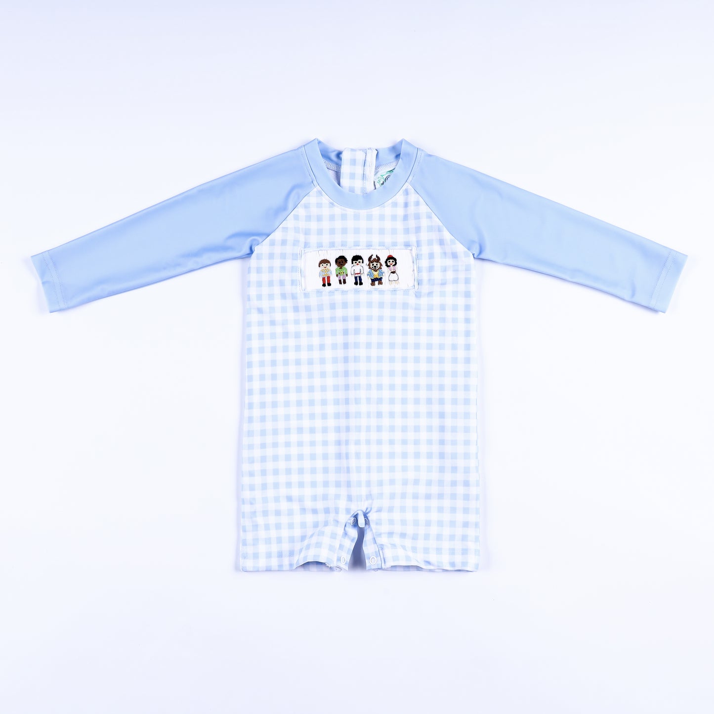 Boys light blue gingham hand smocked handsome prince rash guard swimsuit featuring long sleeves and snap legs.
