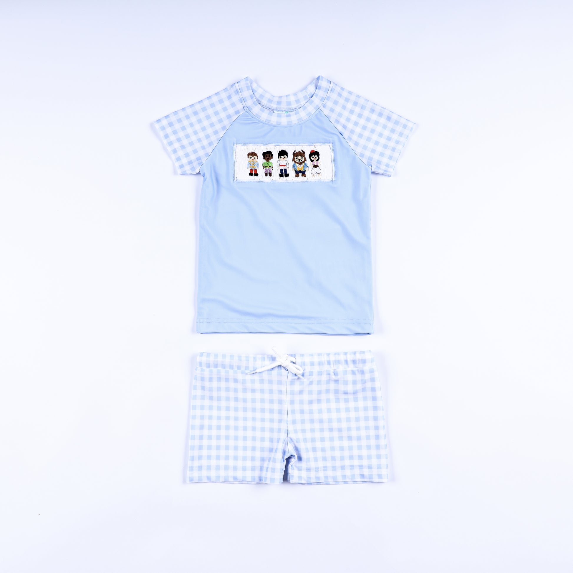 Boys handsome prince hand smocked two piece rash guard swimsuit with light blue top and gingham swim trunks front view.