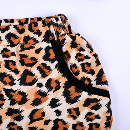 Detail of boys leopard print shorts with elastic waistband and black-trimmed side pocket for safari set.