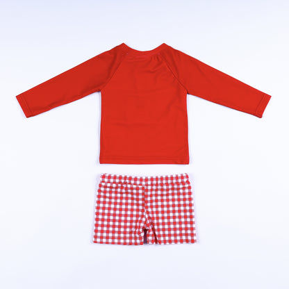 Back view of the boys red long sleeve swim rash guard top and matching red and white gingham swim trunks.