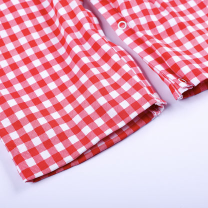 Detailed view of bottom leg opening and snap closures on classic red gingham hand smocked jon jon for baby boys.