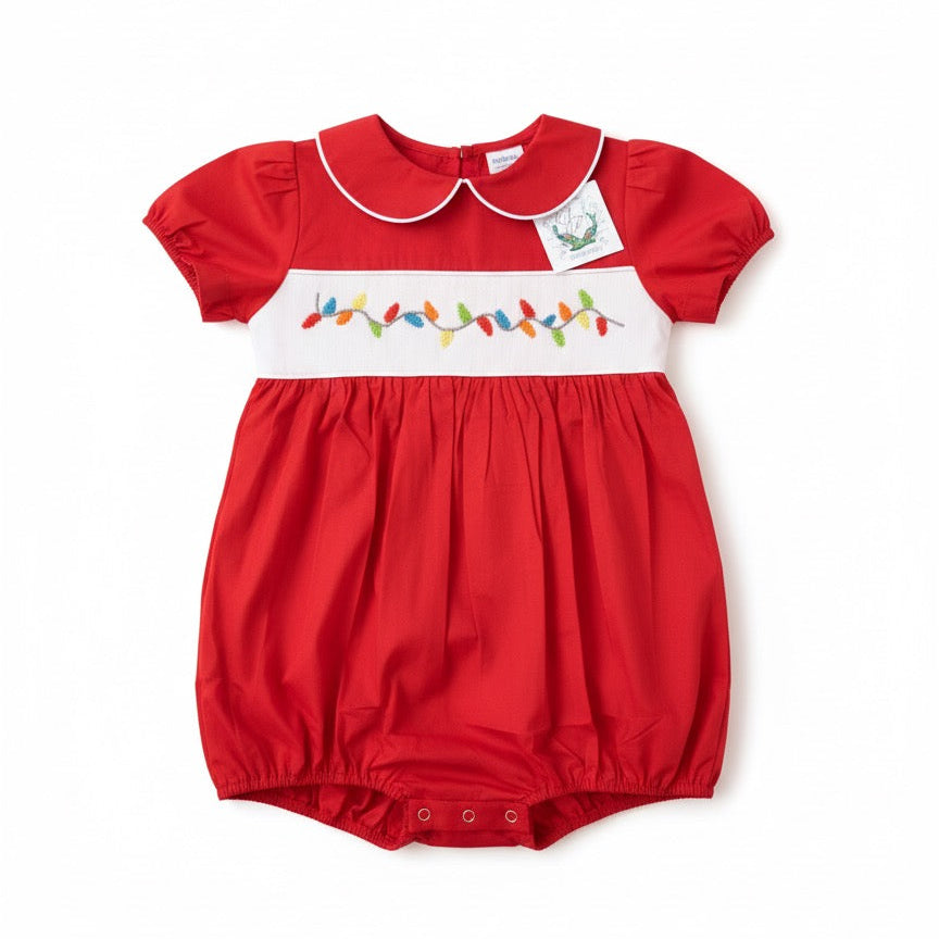 Baby boy red holiday bubble with white Peter Pan collar and hand-smocked colorful Christmas lights.