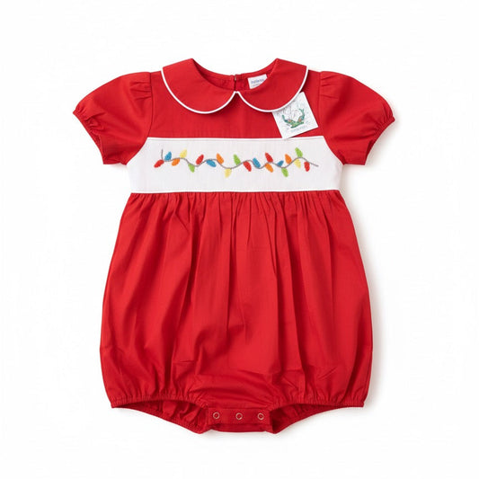 Baby boy red holiday bubble with white Peter Pan collar and hand-smocked colorful Christmas lights.
