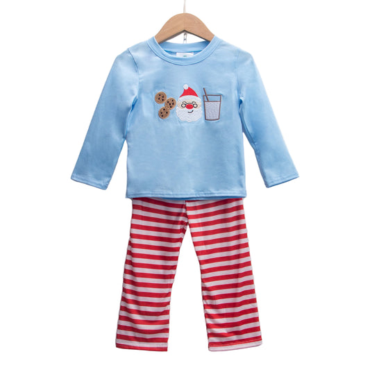 Boys blue top with embroidered Santa, milk, and cookies appliqué paired with red and white striped pants.