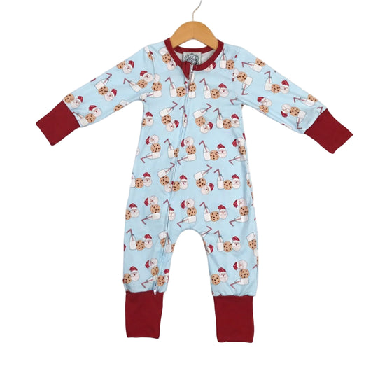 Boys blue zippy pajamas with red cuffs featuring a pattern of Santa, milk, and cookies.
