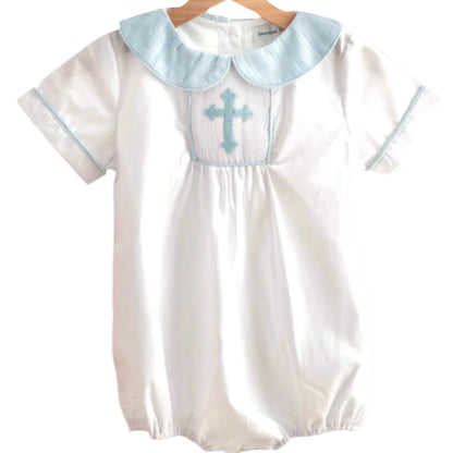 Boys white hand smocked bubble romper with light blue cross embroidery and collar, perfect for baptism or christening.