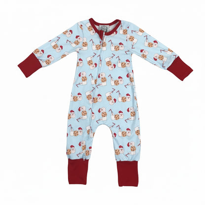 Boys blue zippy pajamas with red cuffs featuring a pattern of Santa, milk, and cookies.