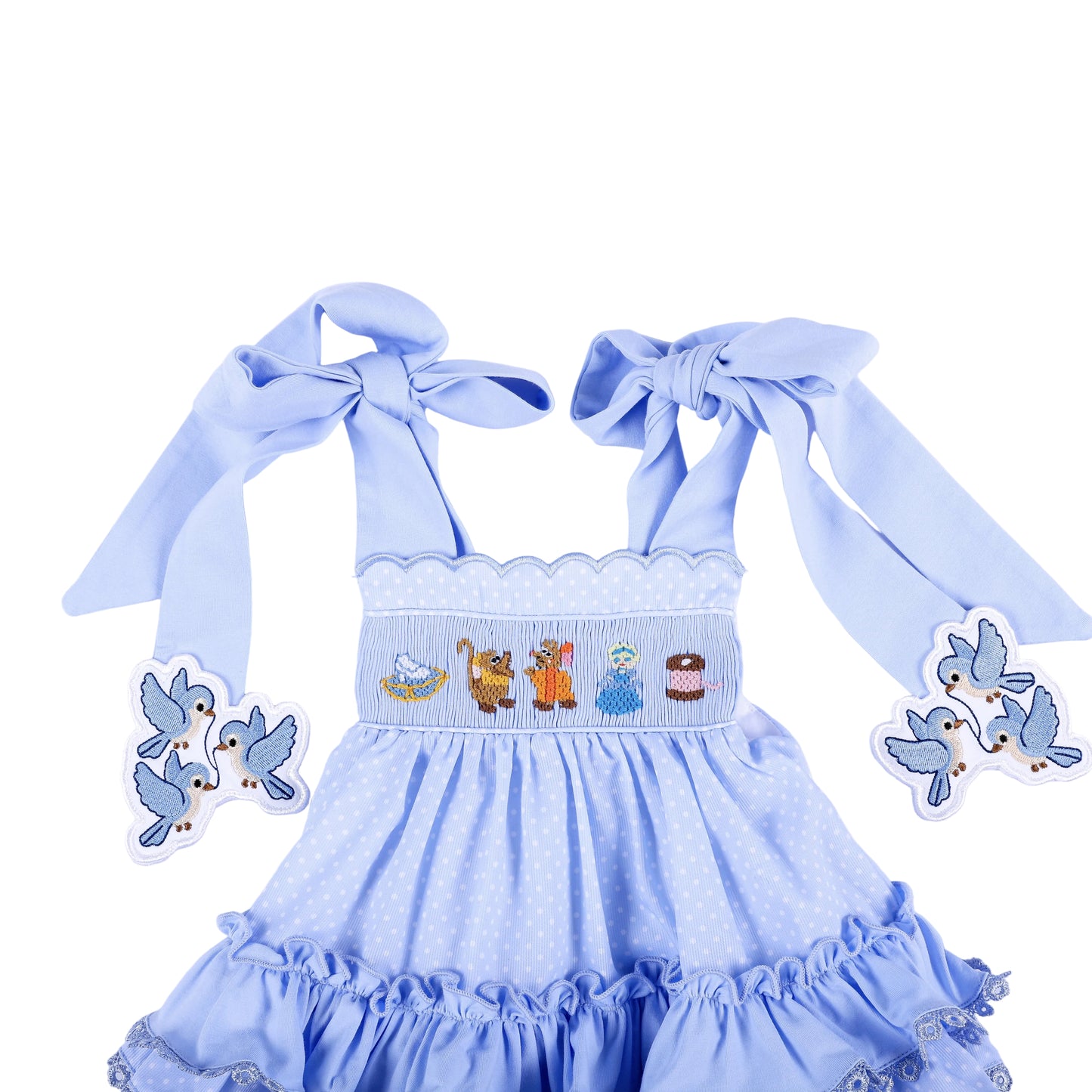 Front detail of Cinderella hand smocked blue ruffle top showing character chest embroidery and tied bow straps.