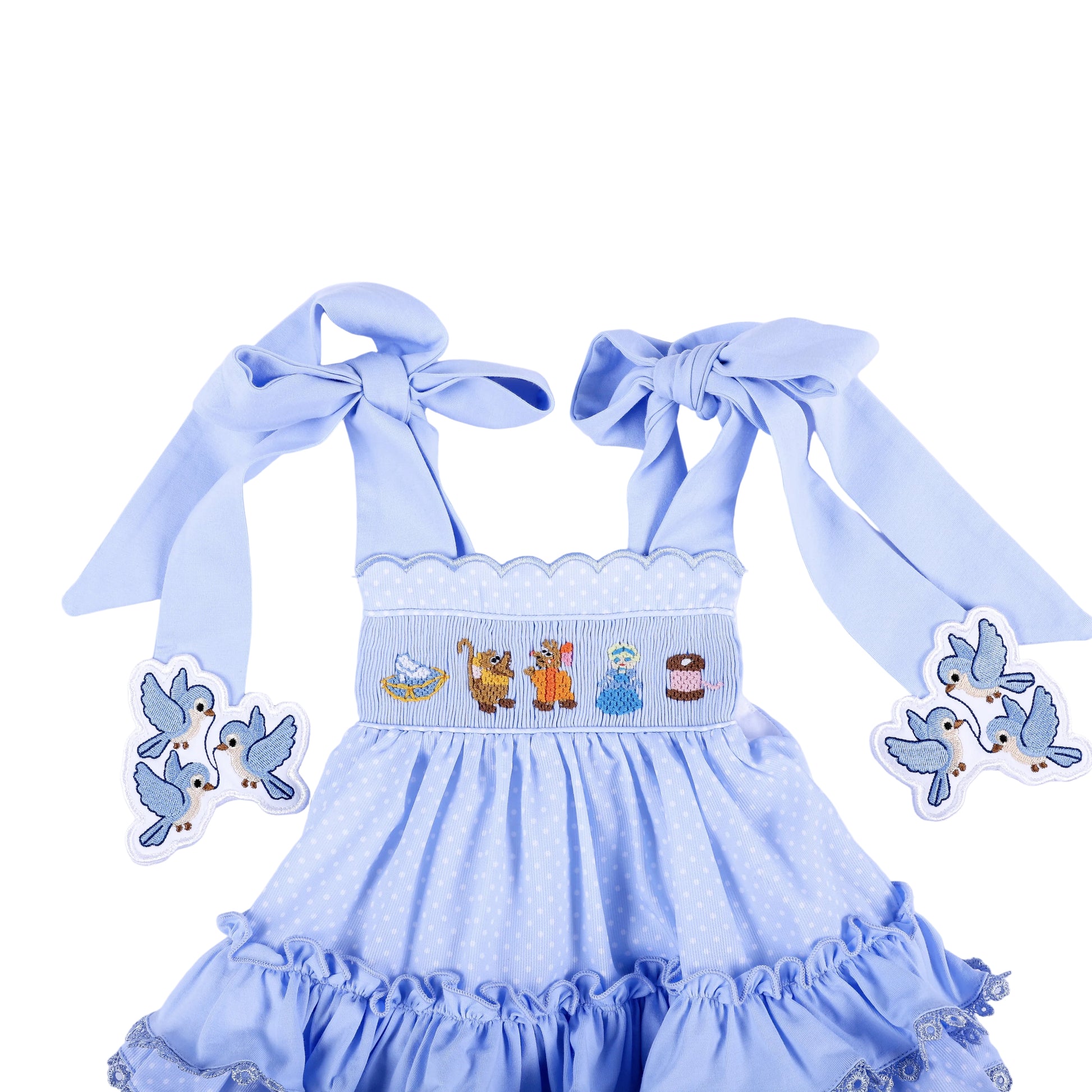 Front detail of Cinderella hand smocked blue ruffle top showing character chest embroidery and tied bow straps.