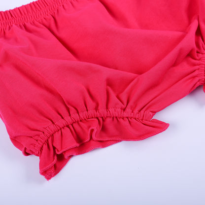 Detailed close up view of the dark pink ruffled bloomer fabric and elastic waistband from the Dolly & Me outfit.