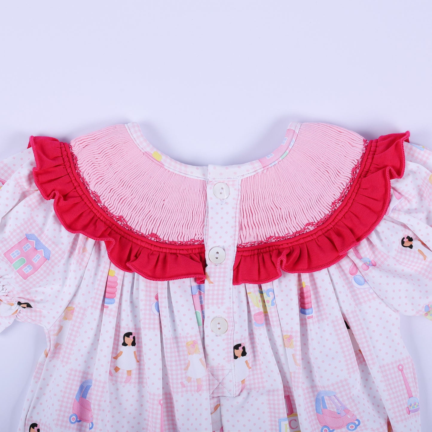 Close-up of the upper back buttons and smocked neckline detail on Dolly & Me pink checkered infant baby bubble romper.