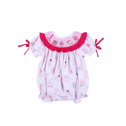 Front view of the Dolly & Me pink checkered smocked bubble romper with vintage toy prints and hot pink ruffles.