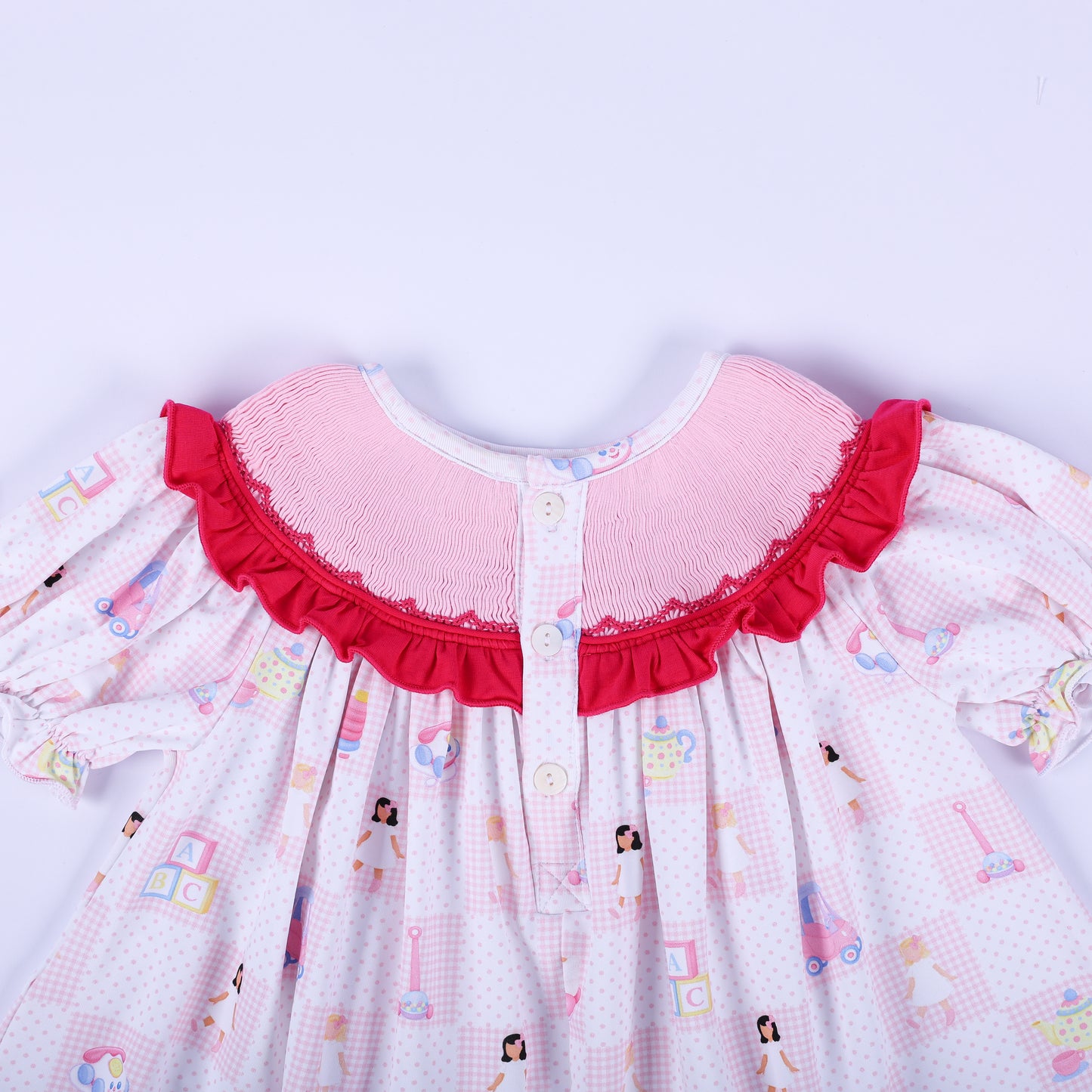 Detailed view of the button back closure and hand smocked ruffle neckline on Dolly & Me vintage toys tunic top.