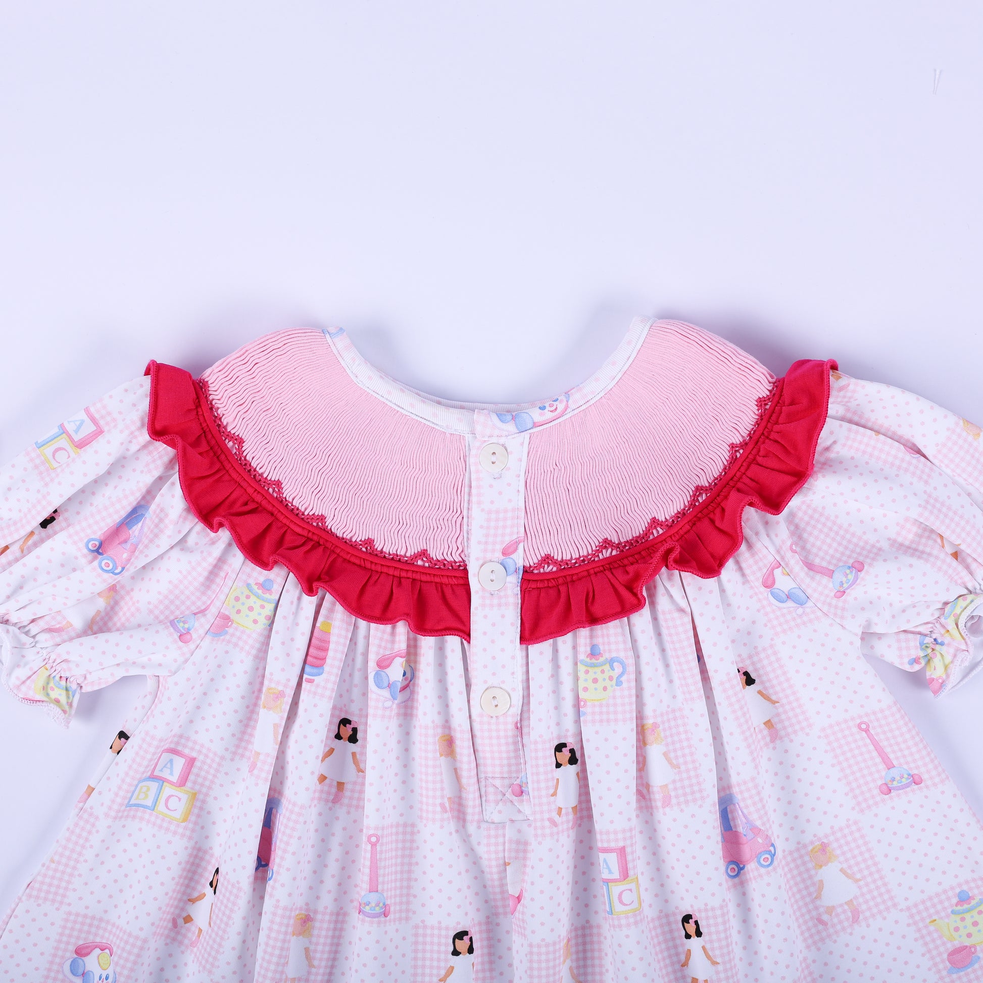 Detailed view of the button back closure and hand smocked ruffle neckline on Dolly & Me vintage toys tunic top.
