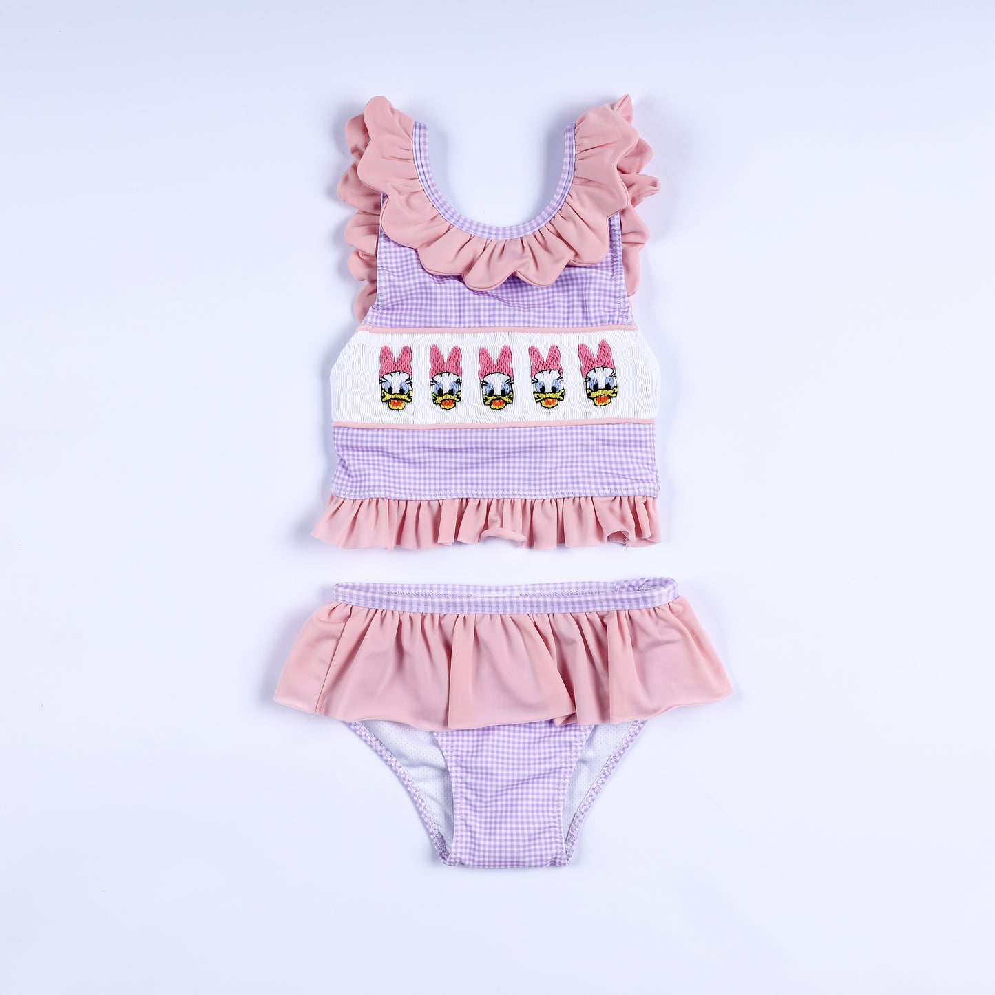 Girls purple gingham two-piece swimsuit featuring hand-smocked embroidered lady ducks and ruffle trim.