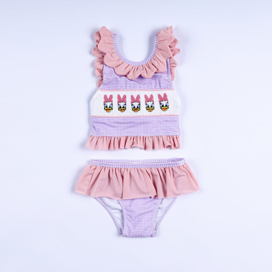Girls purple gingham two-piece swimsuit featuring hand-smocked embroidered lady ducks and ruffle trim.
