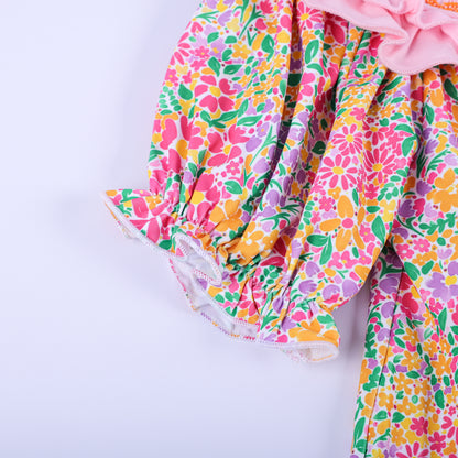 Close-up view of the vibrant pink, orange, and yellow floral ruffle puff sleeve on the boutique Thanksgiving tunic top.
