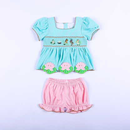Full front view of frog princess hand smocked aqua polka dot top and pink bloomer set for toddler girls.