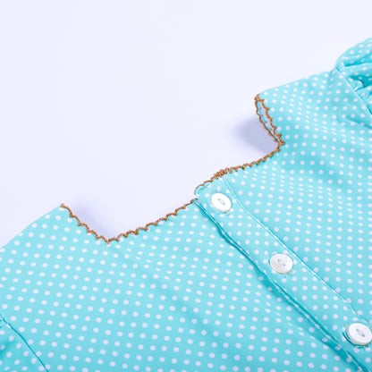 Detailed close-up view of back button placket and picot trimmed collar on girls frog princess smocked dress.