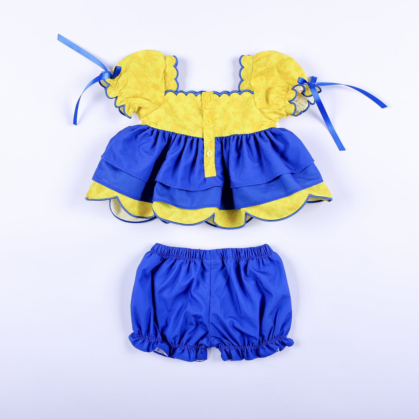 Back view of girls Belle and Beast set showing yellow button closure back top and blue elastic waistband bloomers.