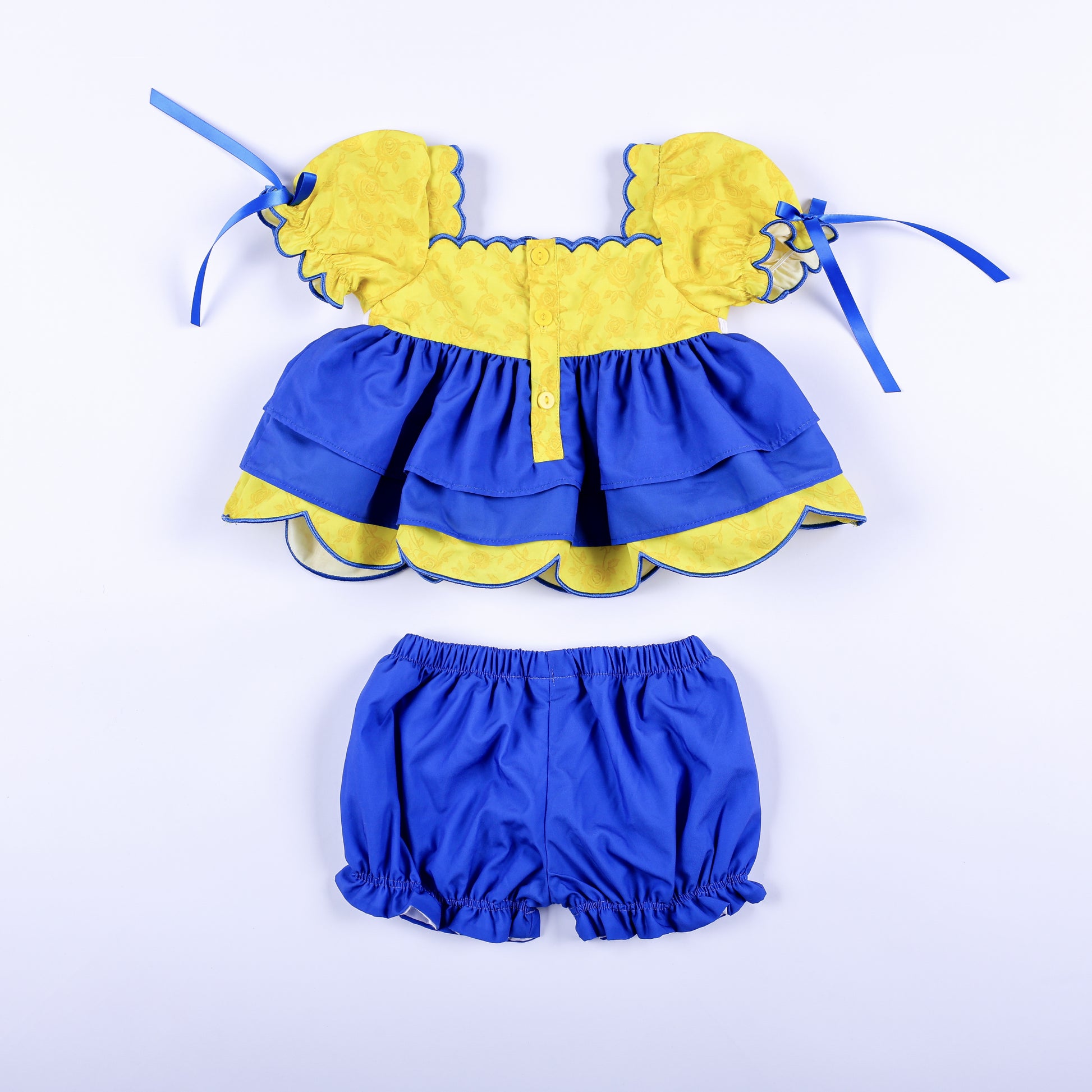Back view of girls Belle and Beast set showing yellow button closure back top and blue elastic waistband bloomers.
