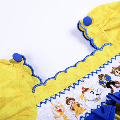Scalloped blue trim neckline and button detail on girls yellow floral custom hand-smocked fairytale top.
