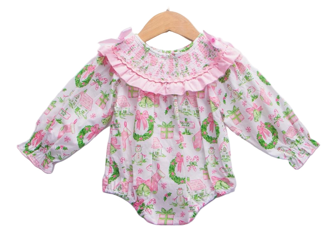 Baby girls Christmas watercolor smocked bubble romper with pink ruffled collar hanging on wooden hanger.