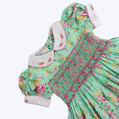 Girls mint floral smocked dress showing embroidered Peter Pan collar and puff sleeves