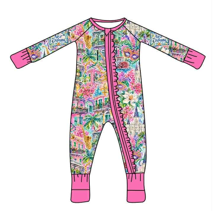 Watercolor New Orleans print baby sleeper with pink zipper ruffle, cuffs, and neckline.