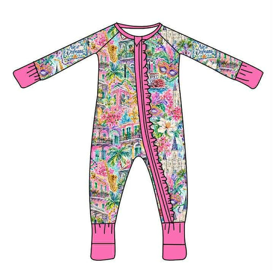 Watercolor New Orleans print baby sleeper with pink zipper ruffle, cuffs, and neckline.