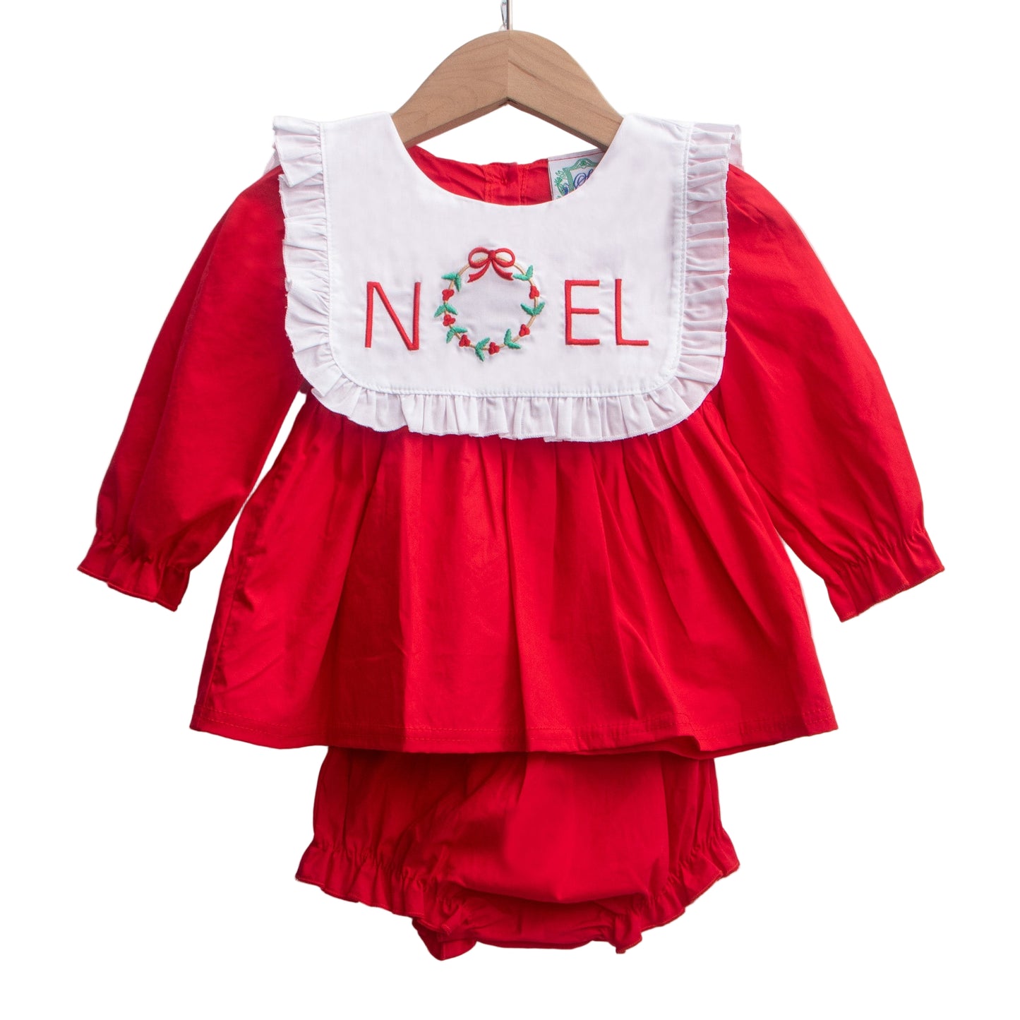 Girls red Christmas bloomer set with white bib, ruffle trim, and embroidered NOEL wreath. 2 piece outfit.