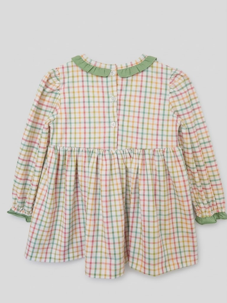 Back view of girls plaid Thanksgiving tunic dress featuring button closures and ruffled collar.