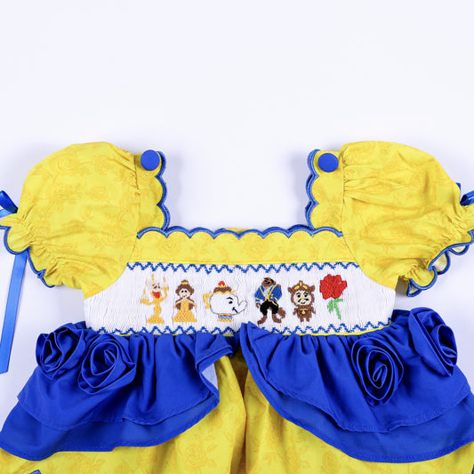 Girls hand-smocked yellow top bodice featuring Belle and Beast embroidered characters with royal blue rose trim.
