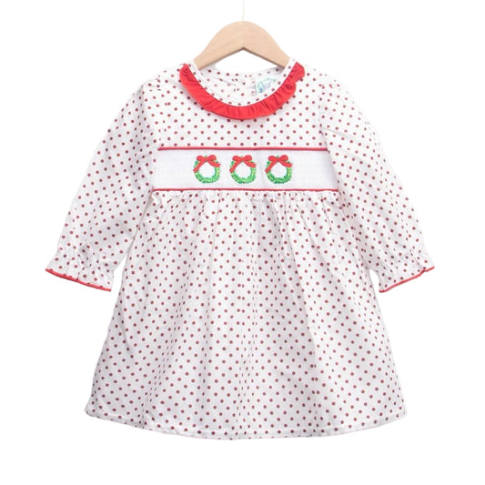 Girls white smocked Christmas dress, red polka dots, red ruffle collar, and three embroidered wreaths on smocked panel.