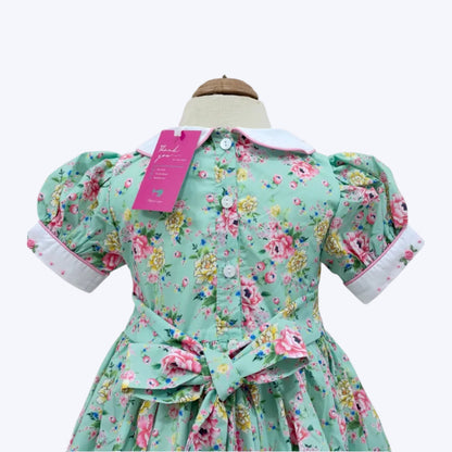 Mannequin back view of girls mint floral dress with Peter Pan collar and sash bow