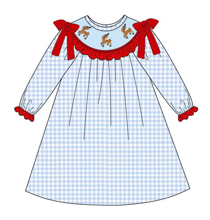 Girls hand smocked blue gingham dress with red bows and trim, featuring embroidered reindeer smocking for Christmas.