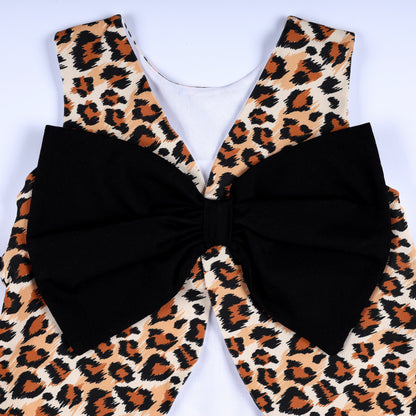 Close-up view of the oversized black statement back bow on the girls leopard print safari smocked top.