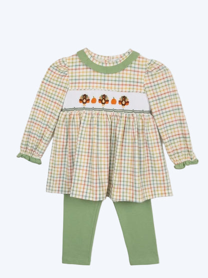Girl Thanksgiving outfit with smocked turkey plaid tunic and sage green leggings.