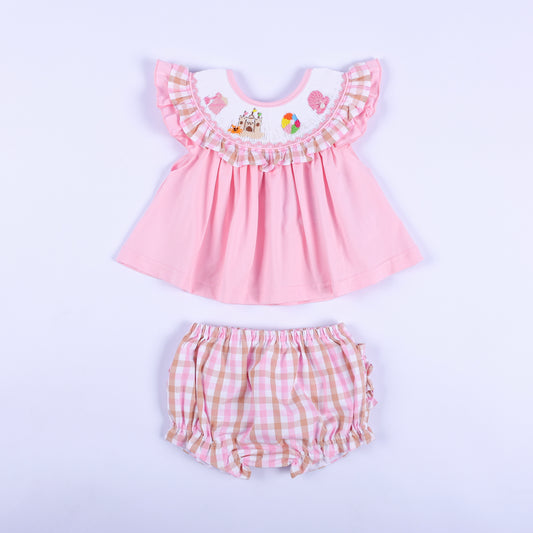 Front view of baby girl pink hand smocked beach theme top with matching pink gingham diaper cover bloomer set.