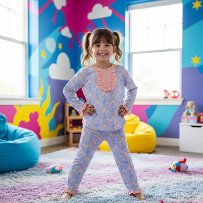 Smiling girl standing in front view wearing blue Grandmillennial Easter Bunny pajama set in a bedroom scene.